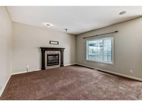 100 Cranberry Circle Se, Calgary, AB - Indoor Photo Showing Other Room With Fireplace