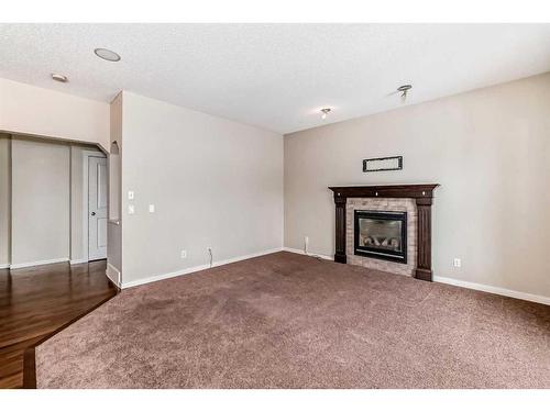 100 Cranberry Circle Se, Calgary, AB - Indoor Photo Showing Living Room With Fireplace