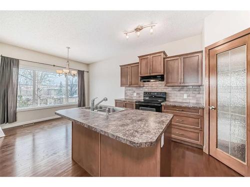 100 Cranberry Circle Se, Calgary, AB - Indoor Photo Showing Kitchen With Double Sink