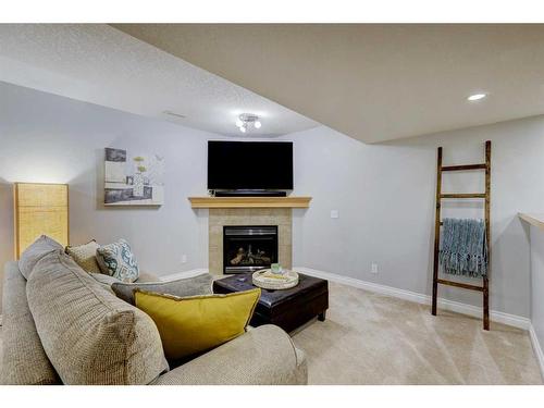 215 Gleneagles View, Cochrane, AB - Indoor Photo Showing Other Room With Fireplace