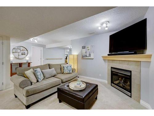 215 Gleneagles View, Cochrane, AB - Indoor Photo Showing Living Room With Fireplace
