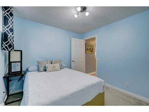 215 Gleneagles View, Cochrane, AB - Indoor Photo Showing Bedroom
