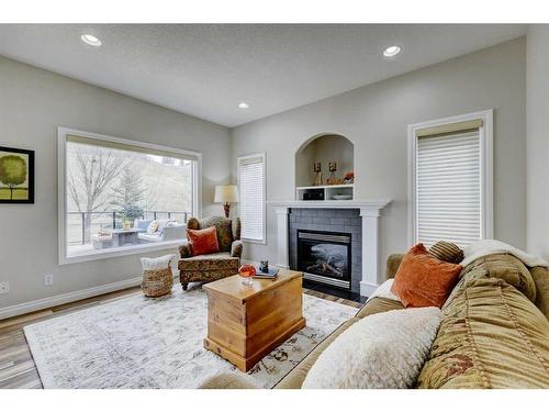 215 Gleneagles View, Cochrane, AB - Indoor Photo Showing Living Room With Fireplace