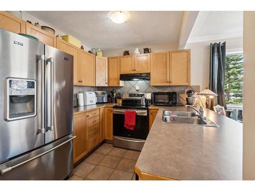82 Eversyde Court Sw, Calgary, AB - Indoor Photo Showing Kitchen With Stainless Steel Kitchen With Double Sink