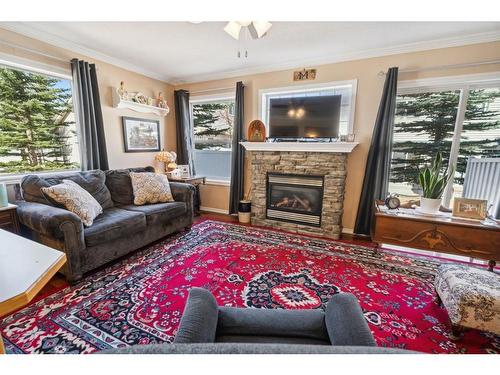 82 Eversyde Court Sw, Calgary, AB - Indoor Photo Showing Living Room With Fireplace