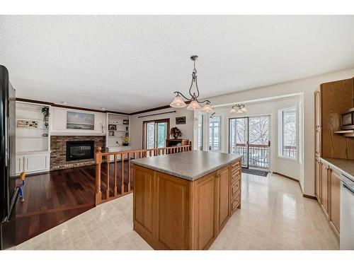 240 Deer River Place Se, Calgary, AB - Indoor Photo Showing Kitchen With Fireplace
