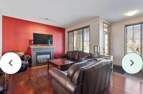 1819 New Brighton Drive Se, Calgary, AB - Indoor Photo Showing Living Room With Fireplace