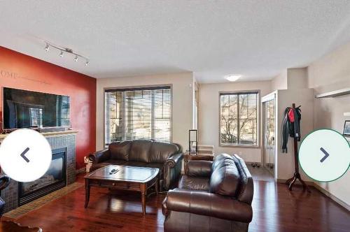 1819 New Brighton Drive Se, Calgary, AB - Indoor Photo Showing Living Room With Fireplace