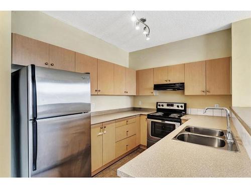 2122-1140 Taradale Drive Ne, Calgary, AB - Indoor Photo Showing Kitchen With Stainless Steel Kitchen With Double Sink