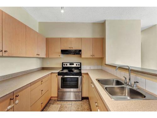 2122-1140 Taradale Drive Ne, Calgary, AB - Indoor Photo Showing Kitchen With Double Sink