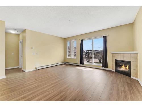2122-1140 Taradale Drive Ne, Calgary, AB - Indoor Photo Showing Living Room With Fireplace