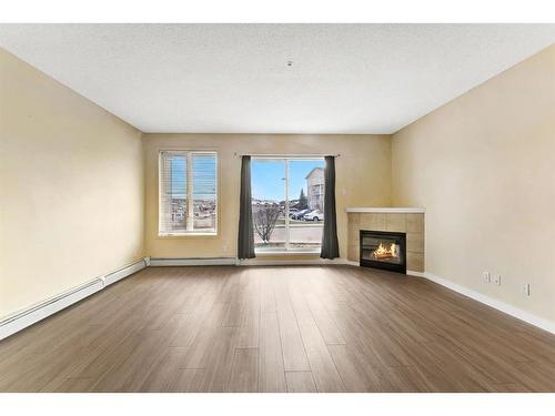 2122-1140 Taradale Drive Ne, Calgary, AB - Indoor Photo Showing Living Room With Fireplace