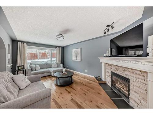 68 Arbour Crest Court Nw, Calgary, AB - Indoor Photo Showing Living Room With Fireplace
