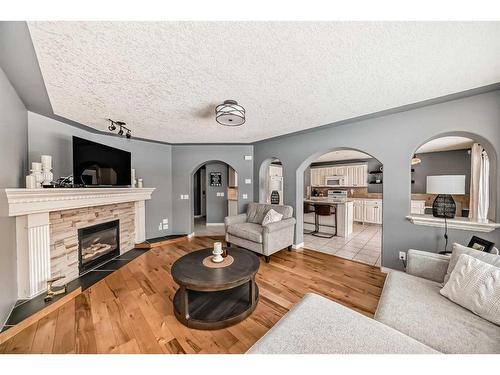 68 Arbour Crest Court Nw, Calgary, AB - Indoor Photo Showing Living Room With Fireplace