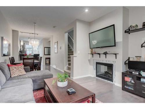 311 Ascot Circle Sw, Calgary, AB - Indoor Photo Showing Living Room With Fireplace
