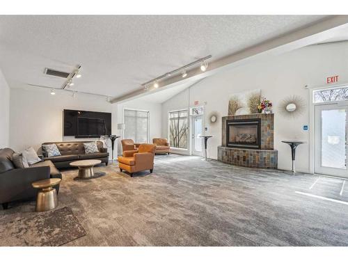 103-6 Hemlock Crescent Sw, Calgary, AB - Indoor Photo Showing Living Room With Fireplace