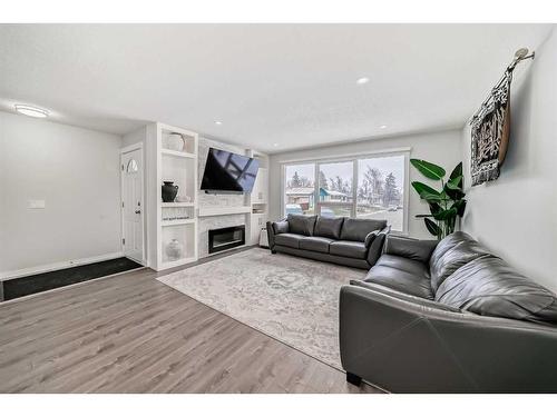 155 Penbrooke Close Se, Calgary, AB - Indoor Photo Showing Living Room With Fireplace