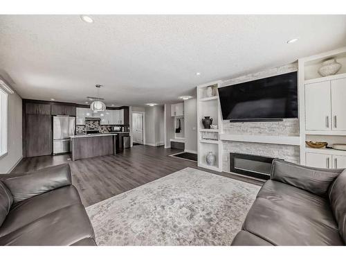 155 Penbrooke Close Se, Calgary, AB - Indoor Photo Showing Living Room With Fireplace