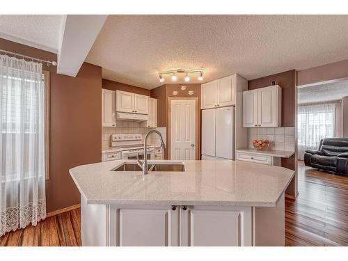 160 Eversyde Circle Sw, Calgary, AB - Indoor Photo Showing Kitchen With Double Sink