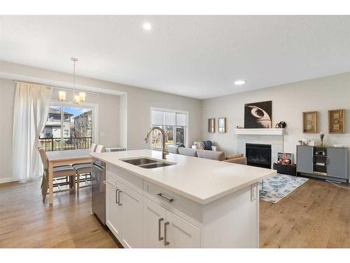 84 Walgrove Terrace Se, Calgary, AB - Indoor Photo Showing Kitchen With Fireplace With Double Sink