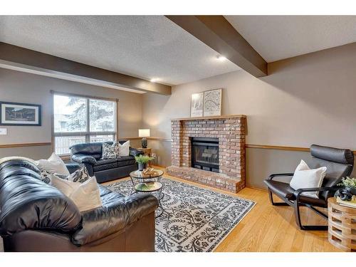 16527 Sunhaven Road Se, Calgary, AB - Indoor Photo Showing Living Room With Fireplace