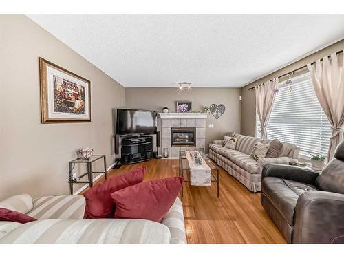 13725 Mt Mckenzie Drive Se, Calgary, AB - Indoor Photo Showing Living Room With Fireplace