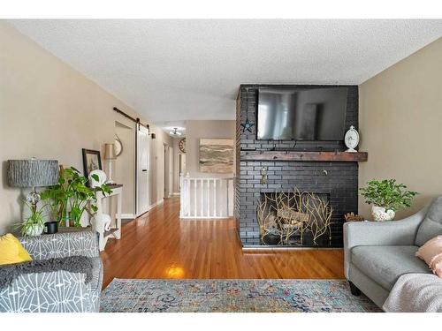 643 Woodsworth Road Se, Calgary, AB - Indoor Photo Showing Living Room With Fireplace