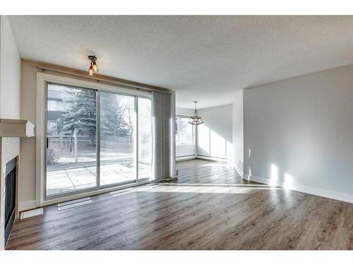 3-104 Village Heights Sw, Calgary, AB - Indoor With Fireplace