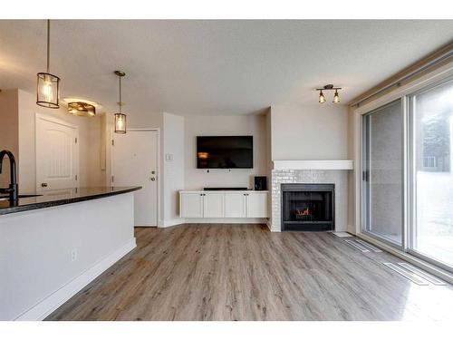 3-104 Village Heights Sw, Calgary, AB - Indoor Photo Showing Living Room With Fireplace