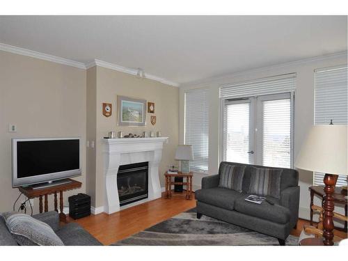 310-1718 14 Avenue Nw, Calgary, AB - Indoor Photo Showing Living Room With Fireplace