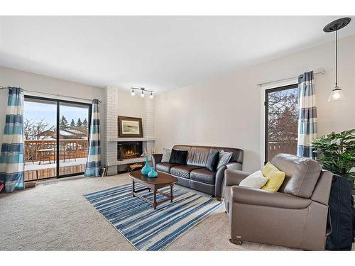 44 Millbank Close Sw, Calgary, AB - Indoor Photo Showing Living Room With Fireplace