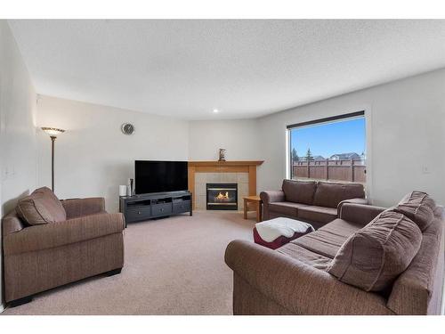 111 Taracove Estate Drive Ne, Calgary, AB - Indoor Photo Showing Living Room With Fireplace