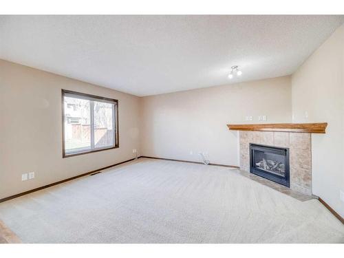 148 Chapman Close Se, Calgary, AB - Indoor With Fireplace