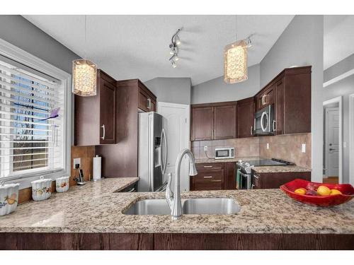 100 Rainbow Falls Row, Chestermere, AB - Indoor Photo Showing Kitchen With Double Sink With Upgraded Kitchen