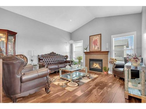 100 Rainbow Falls Row, Chestermere, AB - Indoor Photo Showing Living Room With Fireplace