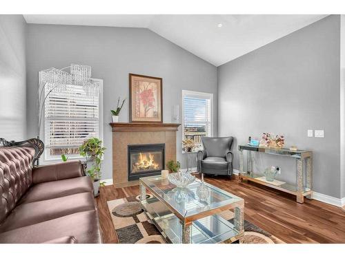 100 Rainbow Falls Row, Chestermere, AB - Indoor Photo Showing Living Room With Fireplace