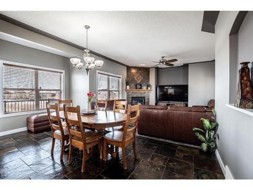 1518 High Park Drive Nw, High River, AB - Indoor Photo Showing Dining Room With Fireplace