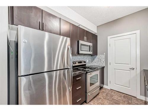 135-23 Millrise Drive Sw, Calgary, AB - Indoor Photo Showing Kitchen With Stainless Steel Kitchen