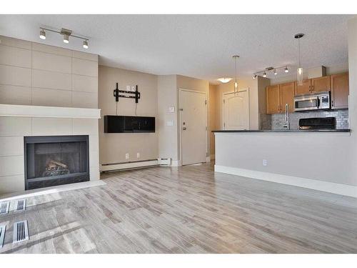 4-101 Village Heights Sw, Calgary, AB - Indoor With Fireplace
