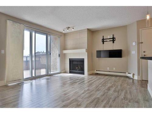 4-101 Village Heights Sw, Calgary, AB - Indoor Photo Showing Living Room With Fireplace