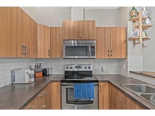 319-10 Auburn Bay Avenue Se, Calgary, AB - Indoor Photo Showing Kitchen With Stainless Steel Kitchen With Double Sink