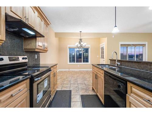 23 Taracove Estate Drive Ne, Calgary, AB - Indoor Photo Showing Kitchen With Double Sink