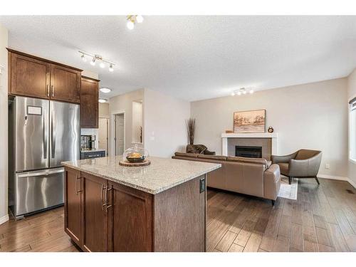 14 Walden Grove Se, Calgary, AB - Indoor Photo Showing Kitchen With Fireplace With Stainless Steel Kitchen