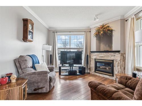 113-78 Prestwick Gardens Se, Calgary, AB - Indoor Photo Showing Living Room With Fireplace