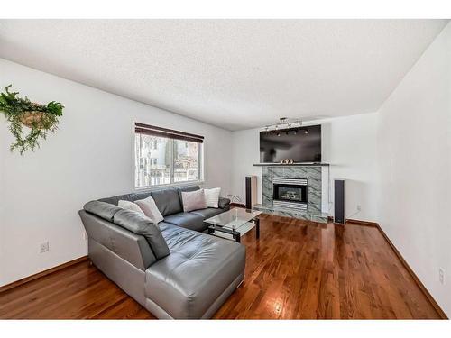 240 Arbour Ridge Way Nw, Calgary, AB - Indoor Photo Showing Living Room With Fireplace