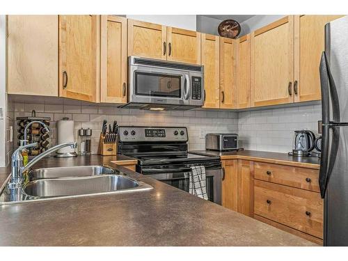 102-101 Montane Road, Canmore, AB - Indoor Photo Showing Kitchen With Double Sink