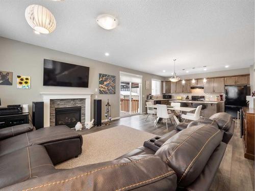12 Yorkstone Heath Sw, Calgary, AB - Indoor Photo Showing Living Room With Fireplace