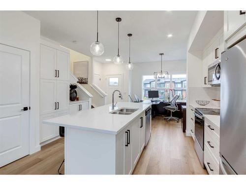 1004-525 River Heights Drive, Cochrane, AB - Indoor Photo Showing Kitchen With Double Sink With Upgraded Kitchen