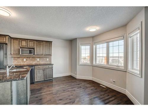 43 Prominence Path Sw, Calgary, AB - Indoor Photo Showing Kitchen With Double Sink