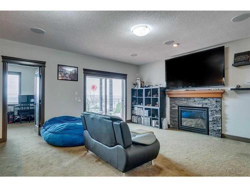163 Sunset View, Cochrane, AB - Indoor Photo Showing Living Room With Fireplace